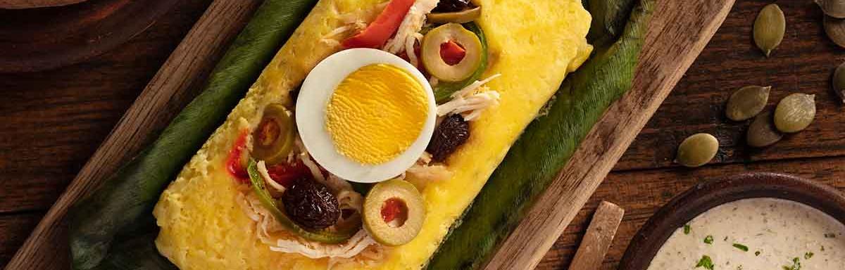 Plato con tamales dulces y salados envuelto en hoja de choclo 